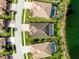 Aerial view of several homes including screened-in pools, surrounded by lush landscaping and a lake at 13238 Famiglia Dr, Venice, FL 34293