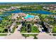 Aerial view of a resort style pool with beautiful clubhouse and tennis courts at 13238 Famiglia Dr, Venice, FL 34293