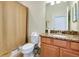 Bathroom featuring a toilet, vanity, granite counters, and tiled flooring at 13238 Famiglia Dr, Venice, FL 34293