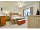 Bedroom featuring a floral bedspread, woven headboard, and bench at 13238 Famiglia Dr, Venice, FL 34293