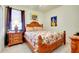 Bedroom featuring wood furniture, floral bedding, and ample natural light at 13238 Famiglia Dr, Venice, FL 34293