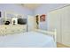 Bright bedroom with a full dresser, large mirror, and ample storage at 13238 Famiglia Dr, Venice, FL 34293