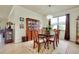 Formal dining room featuring wood table, chairs, china cabinet, chandelier, and floral rug at 13238 Famiglia Dr, Venice, FL 34293