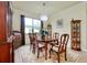 Traditional dining room featuring a chandelier, wood table, and a large floral area rug at 13238 Famiglia Dr, Venice, FL 34293