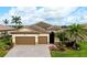 Charming single-Gathering home with a two-car garage, well manicured landscaping, and a tile roof at 13238 Famiglia Dr, Venice, FL 34293