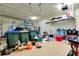 Spacious garage with overhead storage racks and ample space for tools and equipment at 13238 Famiglia Dr, Venice, FL 34293