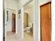 Hallway view of a well-maintained, tiled bathroom with a shower at 13238 Famiglia Dr, Venice, FL 34293