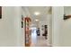 Bright hallway leading to the dining and living areas, showcasing tile floors and neutral wall tones at 13238 Famiglia Dr, Venice, FL 34293