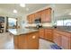 Well-equipped kitchen features granite countertops, a central island, and stainless steel appliances at 13238 Famiglia Dr, Venice, FL 34293