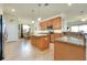 Open kitchen area with granite countertops, stainless steel appliances, and seamless access to the dining area at 13238 Famiglia Dr, Venice, FL 34293