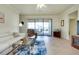 Comfortable living room with sliding glass doors and access to the screened patio at 13238 Famiglia Dr, Venice, FL 34293