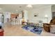 Open-concept living room with views of the kitchen and access to outdoor patio at 13238 Famiglia Dr, Venice, FL 34293