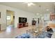 Open-concept living room with tile flooring, a tv entertainment center, and a kitchen bar at 13238 Famiglia Dr, Venice, FL 34293