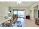 Inviting living room with tiled flooring, sliding glass doors to a screened lanai, and comfortable seating at 13238 Famiglia Dr, Venice, FL 34293