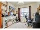 Home office featuring a white cabinet for electronics and a window with views at 13238 Famiglia Dr, Venice, FL 34293