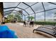 Pool with screened-in patio, chairs, and relaxing lounge seating to enjoy the outdoors at 13238 Famiglia Dr, Venice, FL 34293