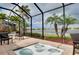 Relaxing pool area with screened-in patio, chairs, and scenic lake view perfect for outdoor living at 13238 Famiglia Dr, Venice, FL 34293