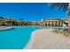Large community pool featuring a curved edge and well-manicured landscaping at 13238 Famiglia Dr, Venice, FL 34293