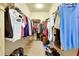 Spacious walk-in closet with clothing racks, shelving, and carpeted floor at 13238 Famiglia Dr, Venice, FL 34293
