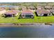 Beautiful aerial view of homes with red tile roofs and manicured lawns in a lakefront community at 13730 Vancanza, Venice, FL 34293