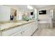 Bright bathroom featuring dual sinks, granite countertops, a soaking tub, walk-in shower, and a wall-mounted TV at 13730 Vancanza, Venice, FL 34293