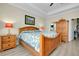 Bedroom featuring a wooden bed frame, dresser and access to ensuite bathroom at 13730 Vancanza, Venice, FL 34293