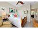 Bedroom with ceiling fan, double closet, attached bathroom, and beach themed decor at 13730 Vancanza, Venice, FL 34293