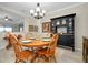 A charming dining room featuring a wooden table, chandelier, and elegant black display cabinet at 13730 Vancanza, Venice, FL 34293