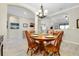 Bright dining room with wooden table set and archway views into other living spaces at 13730 Vancanza, Venice, FL 34293