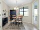 Cozy dining room with elegant chandelier, area rug, and access to outdoor patio at 13730 Vancanza, Venice, FL 34293