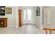 Elegant foyer with tile flooring, decor, and a view of the glass-paneled front door at 13730 Vancanza, Venice, FL 34293