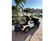 Golf cart with custom wheels parked on a brick driveway at 13730 Vancanza, Venice, FL 34293