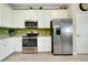 Well-equipped kitchen with stainless steel appliances, white cabinets, and lots of counter space at 13730 Vancanza, Venice, FL 34293