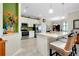 Open kitchen with white cabinets, stainless steel appliances, and an island with seating at 13730 Vancanza, Venice, FL 34293