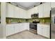 Kitchen featuring stainless steel appliances, white cabinets and granite counters at 13730 Vancanza, Venice, FL 34293