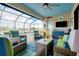 The screened lanai features comfortable seating and a view of the lake and pool at 13730 Vancanza, Venice, FL 34293