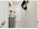 This laundry room is equipped with modern gray appliances and ample storage space at 13730 Vancanza, Venice, FL 34293