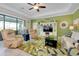 Cozy living room with comfortable seating, a large TV, and a palm-themed area rug at 13730 Vancanza, Venice, FL 34293