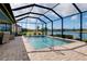 The screened-in pool has a brick paver deck with lake views at 13730 Vancanza, Venice, FL 34293