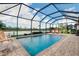 The screened-in pool has a brick paver deck with views of the lake at 13730 Vancanza, Venice, FL 34293