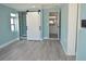 Light blue bedroom with closet, Primary bathroom and barn door at 174 Venice East Blvd, Venice, FL 34293