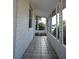 Long porch with brick siding and tile floor at 174 Venice East Blvd, Venice, FL 34293