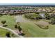 Aerial view of a community featuring a golf course, lakes, and residential homes at 190 Montelluna Dr # North, North Venice, FL 34275