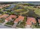 Aerial view of a home with a red tile roof near a lake and golf course at 190 Montelluna Dr # North, North Venice, FL 34275