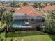 Aerial view of a backyard featuring a screened-in pool and a spa at 190 Montelluna Dr # North, North Venice, FL 34275