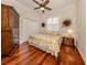 Bedroom featuring hardwood floors, a ceiling fan, and a large wardrobe at 190 Montelluna Dr # North, North Venice, FL 34275