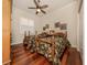 Cozy bedroom featuring two twin beds, hardwood floors, and a ceiling fan at 190 Montelluna Dr # North, North Venice, FL 34275
