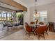 Dining area featuring a chandelier and seating for six, next to the lanai at 190 Montelluna Dr # North, North Venice, FL 34275