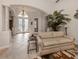 Inviting foyer with high ceilings, tiled floors, decorative chandelier, and a comfortable seating area at 190 Montelluna Dr # North, North Venice, FL 34275