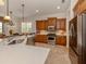 Modern kitchen featuring stainless steel appliances, granite countertops, and a large island at 190 Montelluna Dr # North, North Venice, FL 34275